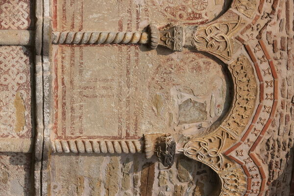 Painted rosettes under the blind arcade of the altar apse